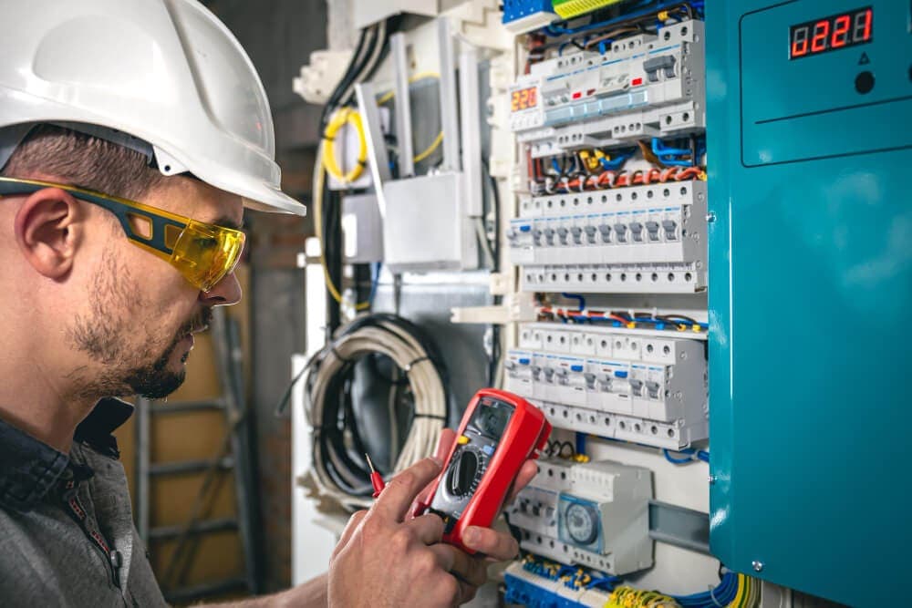 Technician working on electrical panel